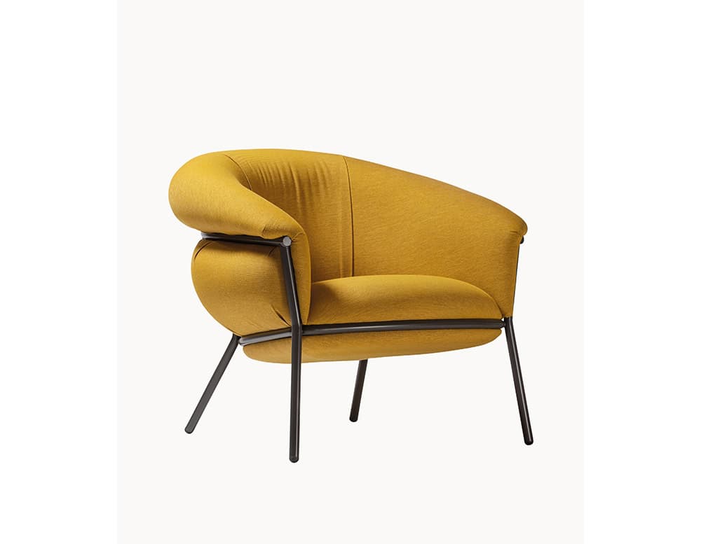 The BD Grasso Armchair is shown in mustard yellow fabric with a black lacquered frame. Its plush upholstery spills over the metal structure, creating a casual yet sculptural silhouette.