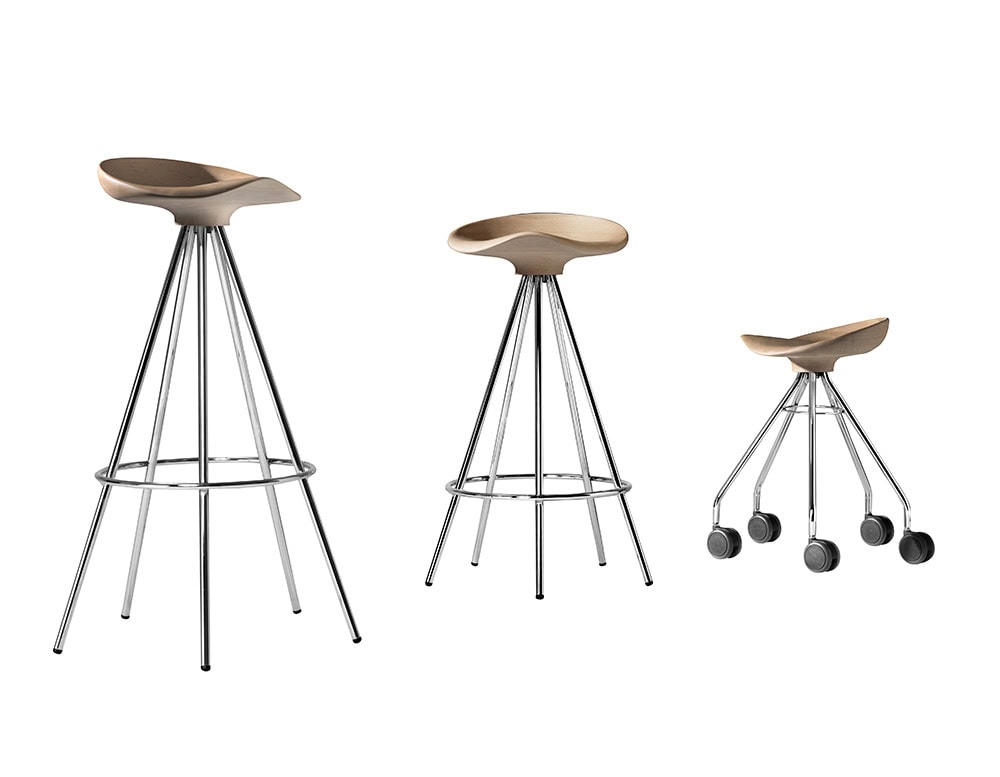 Three Jamaica Stool models with sculpted wooden seats and chrome-finished metal legs: a bar-height stool, a counter-height version, and a compact rolling stool. Sleek, ergonomic, and versatile in form and function.