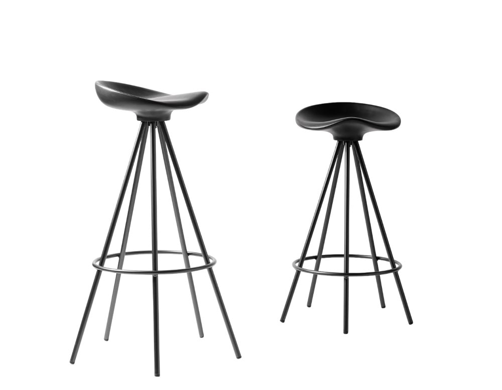 The stool features a black sculpted seat atop sleek black metal legs with a circular footrest, blending minimalism with ergonomic comfort.