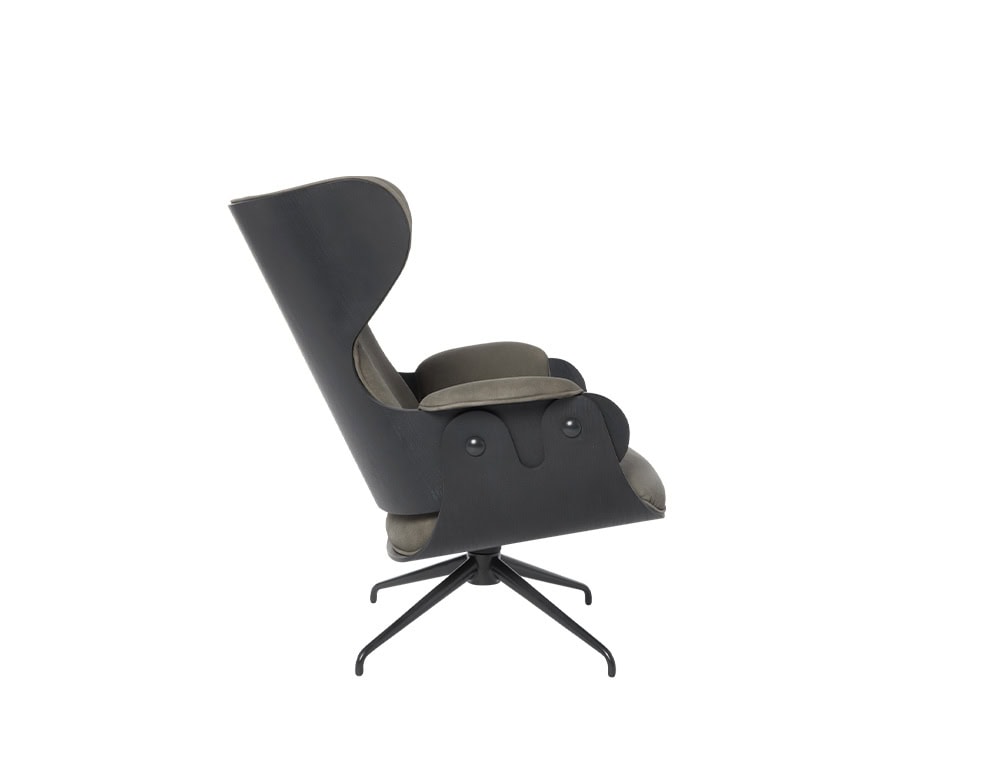 Side profile of the Lounger Armchair in black-stained ash and taupe leather. Showcases its curved silhouette, plush cushions, ergonomic backrest, and four-star swivel base. A balance of sculptural form and inviting comfort.