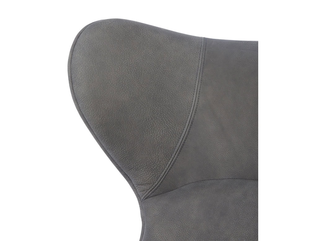 Lounger Armchair detail showcasing the upper backrest’s subtle curvature in rich gray leather. The close-up reveals its supple texture and tailored stitchwork—emphasizing both ergonomic elegance and material sophistication.
