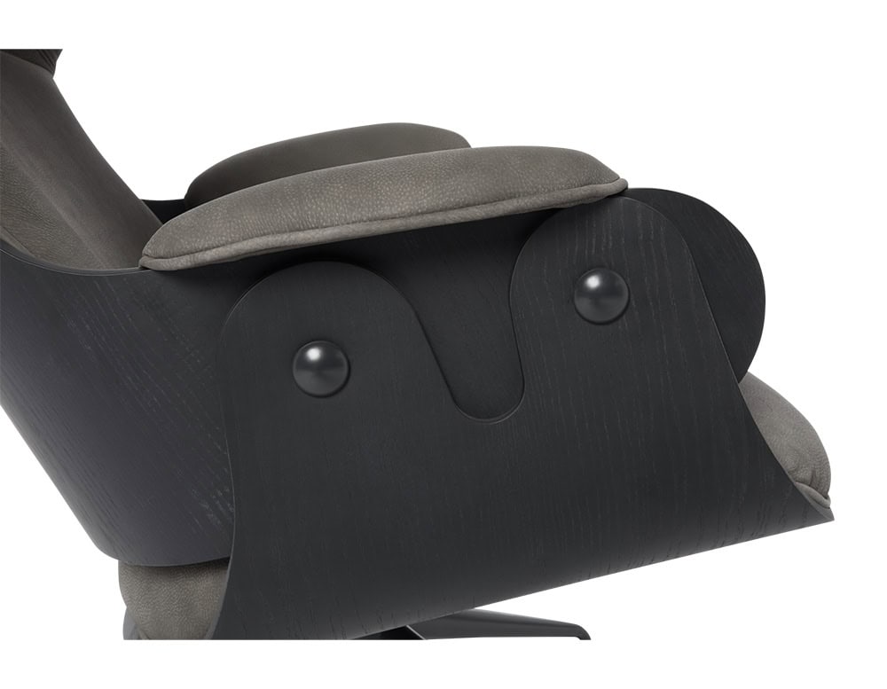 Lounger Armchair in black stained ash with deep gray textured leather upholstery. The close-up reveals its signature sculpted arm detail with dual black accent fasteners-elegant craftsmanship and functional comfort seamlessly fused.