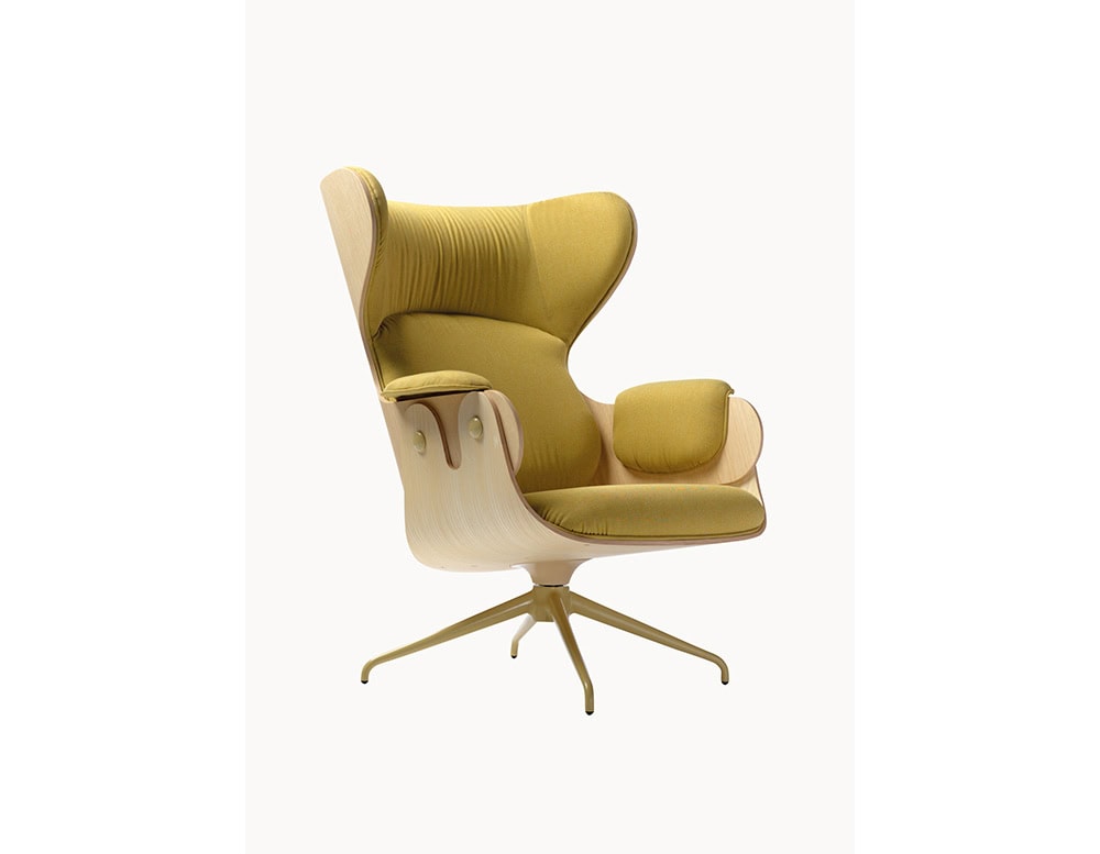 Lounger Armchair with a light wood shell and mustard yellow upholstery. Its organic curves, plush cushioning, and swivel base combine comfort with a bold, modern aesthetic.