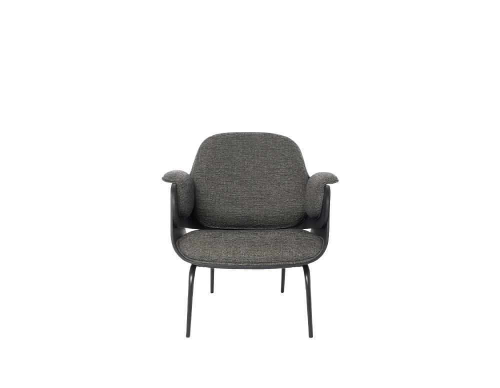 An inviting lounge chair with generous, curved cushions in soft grey fabric. The armrests are padded and slightly elevated, adding comfort and a playful touch to the chair’s clean-lined black frame.