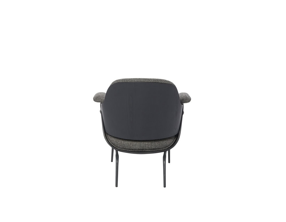 Low Lounger Armchair rear view with slender legs and a matte black wooden shell. Upholstered in textured dark fabric, its compact, sculpted form delivers modern refinement and subtle elegance from every angle.