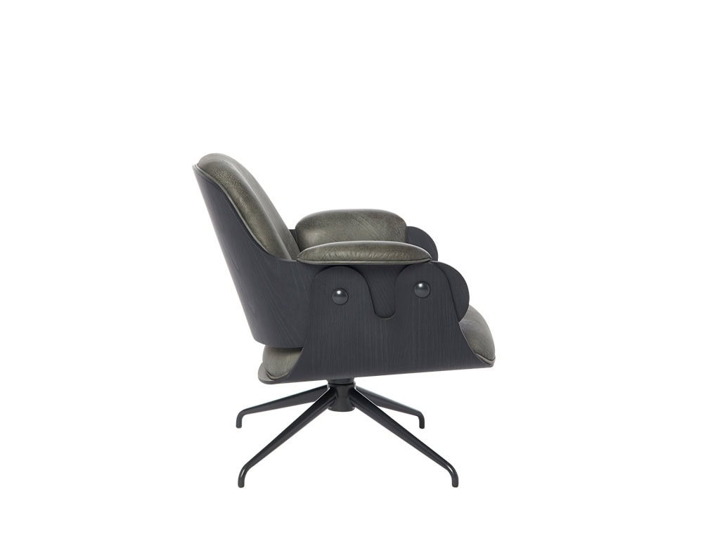 Low Lounger Armchair featuring black oak outer shell and deep gray leather upholstery. Compact silhouette and reclined profile supported by a 4-star matte black swivel base. Sculptural side profile with signature wave detail and button accents.