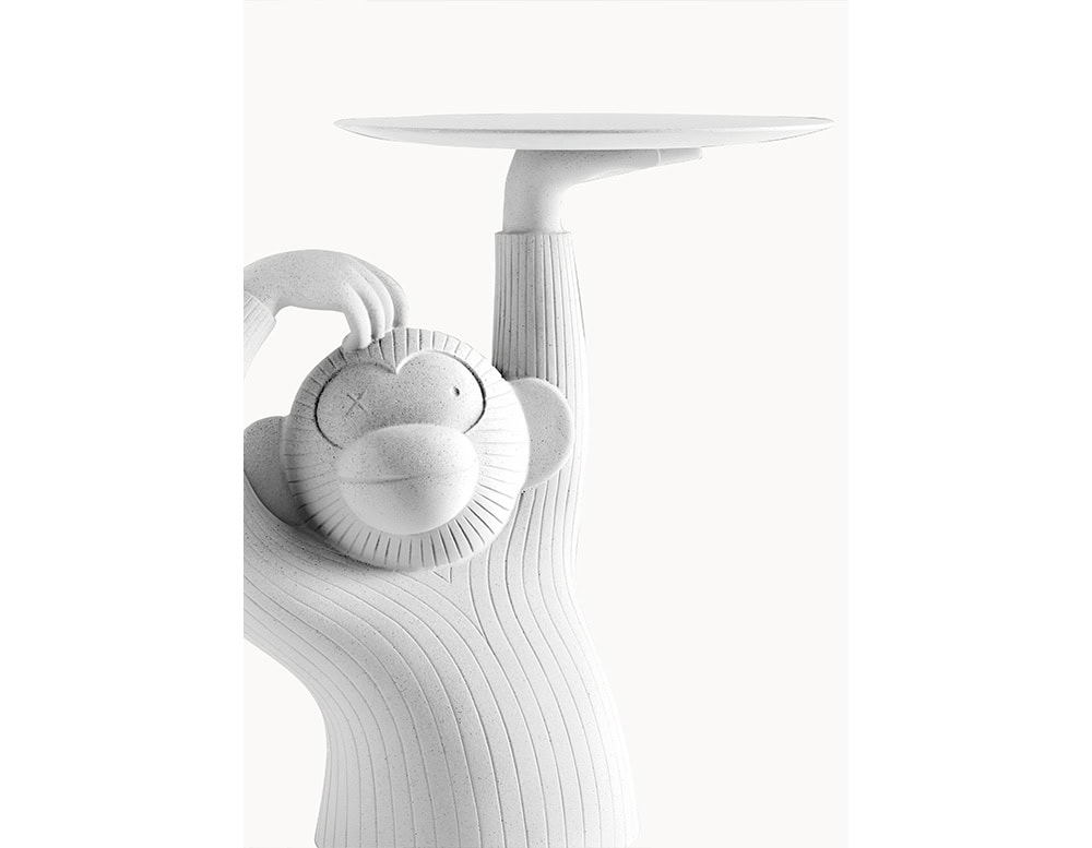 A playful side table shaped like a monkey, sculpted in textured white resin with a smooth circular tray balanced overhead. Its curved lines and whimsical expression add a sense of humor and personality to any room.