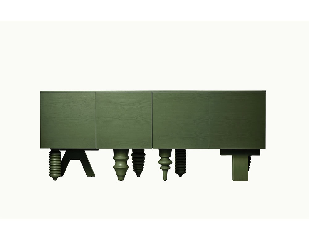 Olive green cabinet with minimalist doors, elevated on a mix of eclectic, sculptural legs that contrast classical profiles with industrial silhouettes.