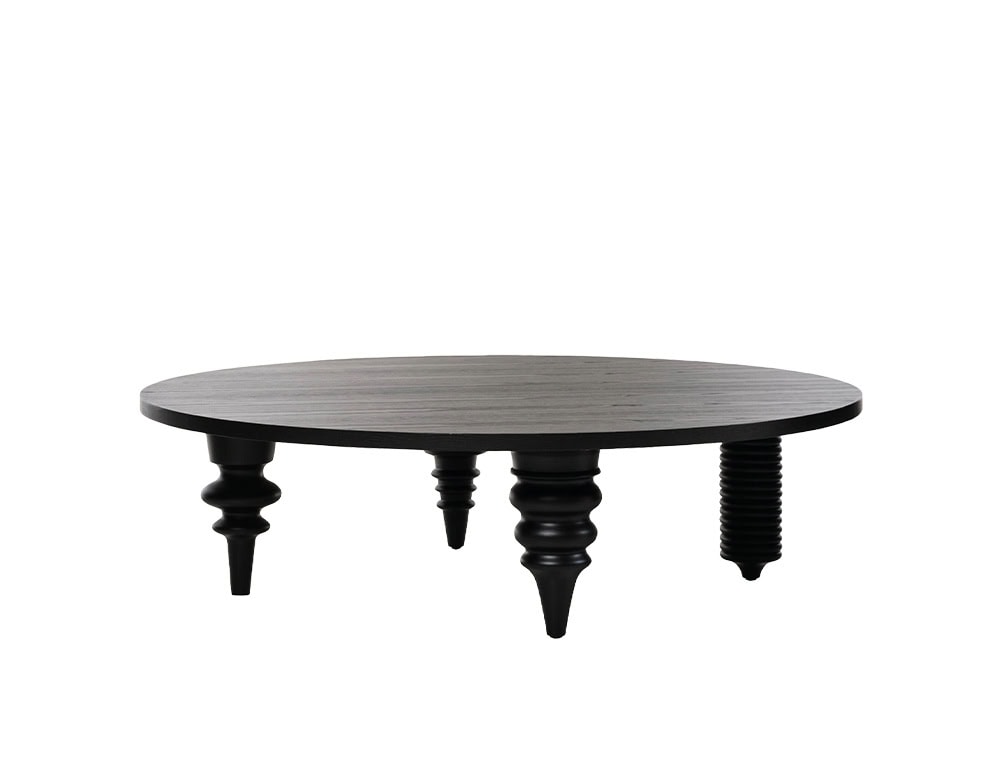 Multileg Coffee Table featuring a circular top in black-stained wood and five unique, sculpturally carved legs in varying shapes. The eclectic leg design brings a playful yet sophisticated character to this low-profile, modern table.