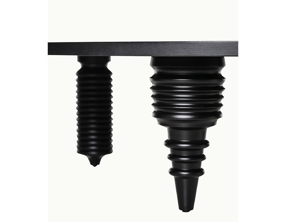 Multileg Coffee Table leg detail in black finish. Sculptural turned wood legs show off playful, asymmetric forms that give each table a unique character.