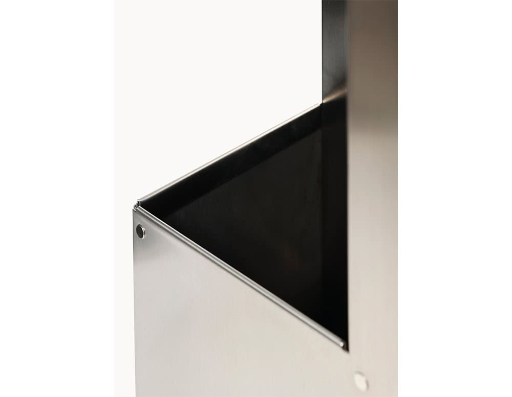 Stainless steel umbrella stand, highlighting its sharp-edged geometry and the seamless junction of its polished metal surfaces.