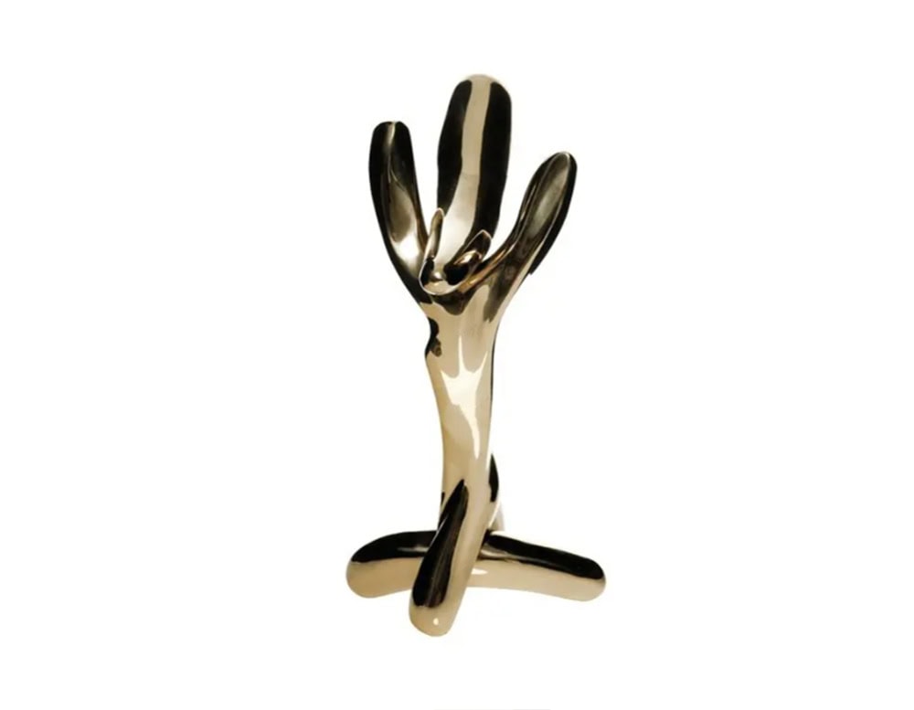 Sculptural door knob in polished gold finish with fluid, branching forms, reflective surface and abstract shape blend function with artistic expression.