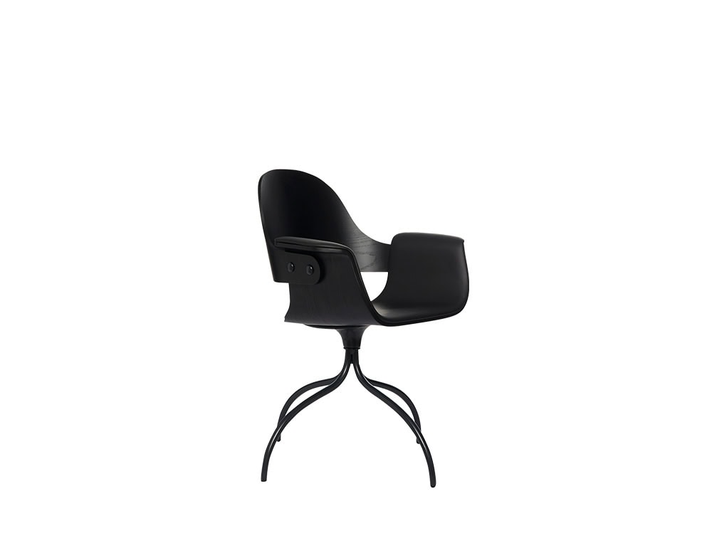 Curved black wood chair with sculptural armrests and a molded seat, perched on four gracefully arched metal legs that meet at a central point, creating an elegant and modern silhouette.