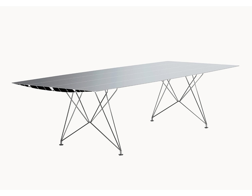 The BD Table B features a sleek, aluminum tabletop with a tapered aerodynamic profile. Its metallic base consists of fine intersecting rods, adding structural lightness and visual transparency.