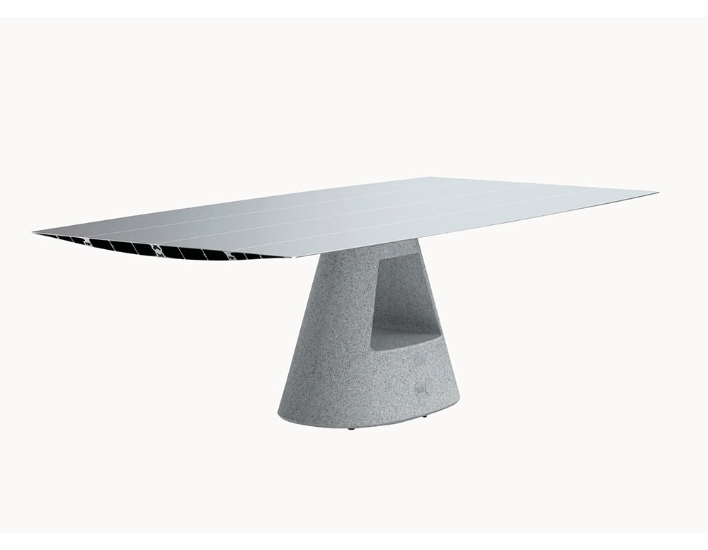 The BD Table B features a sleek aluminum tabletop paired with a sculptural concrete base. Its design combines industrial precision with architectural stability, emphasizing both function and form.