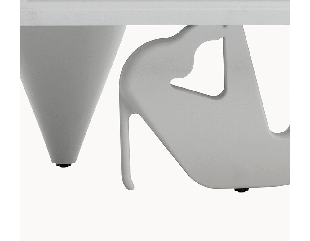 Close-up of two sculptural cabinet legs, one shaped like a conical spike and the other resembling a stylized high-heeled shoe, both in matte white finish.
