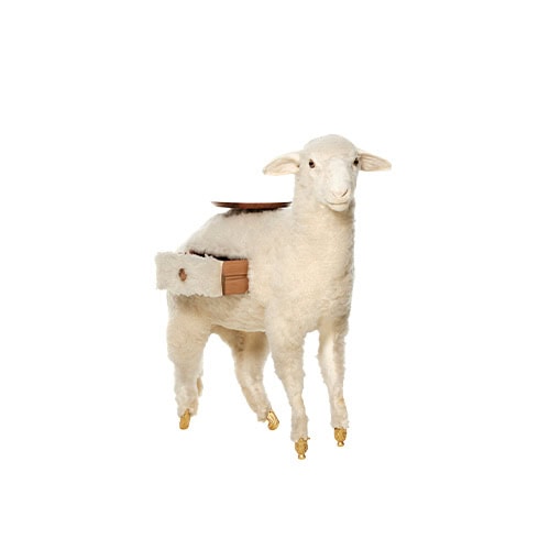A whimsical sheep-shaped piece with golden hoof accents and a circular wooden tray balanced on its back. On one side, a small functional drawer is revealed, combining playful design with hidden storage.