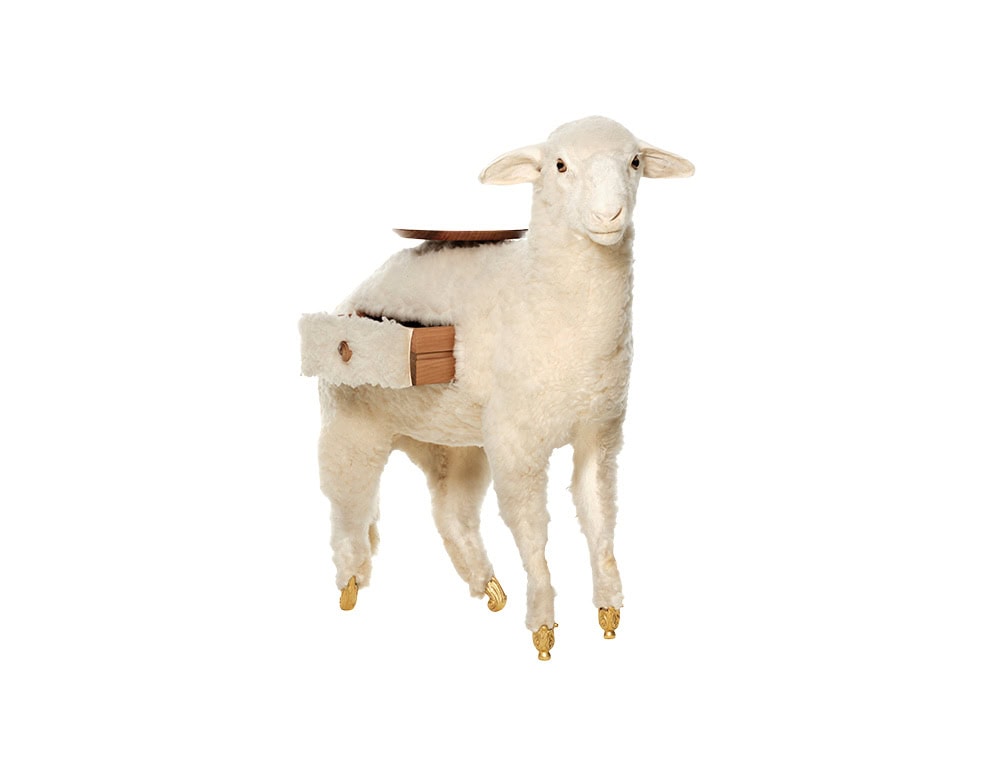 Sheep-shaped piece with golden hoof details and a small wooden dish balanced on its back. One side of the body reveals a functional drawer, adding a playful storage element to this whimsical design.