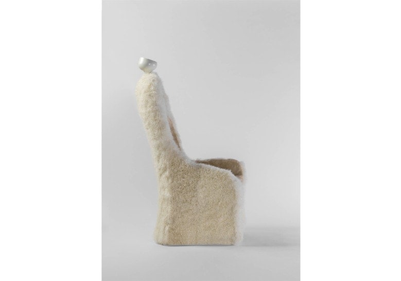 armchair made of sheepskin in the shape of a human silhouette in a white tone