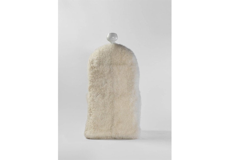 armchair made of sheepskin in the shape of a human silhouette in a white tone