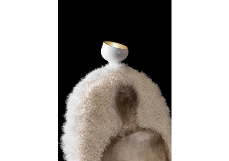 armchair made from a wooden base and upholstered in sheepskin