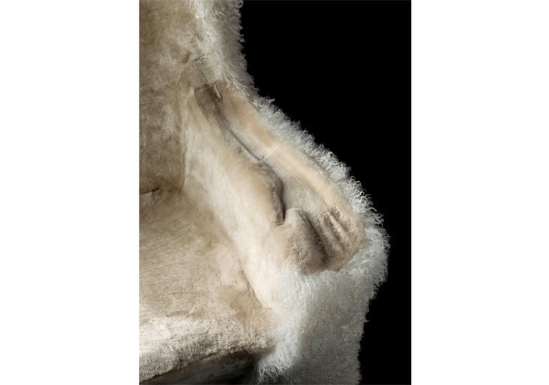 armchair made from a wooden base and upholstered in sheepskin