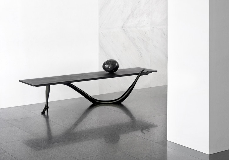 table made of black patina base and marble top in a black tone