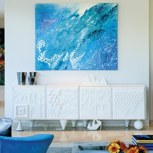 sideboard made of wood with an engraved design on its structure in a white tone