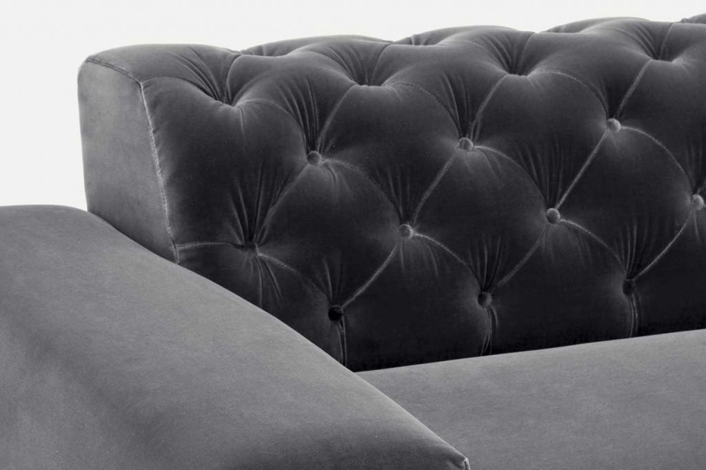 sofa with backrest made of fabric base in a gray color and design with decorative buttons