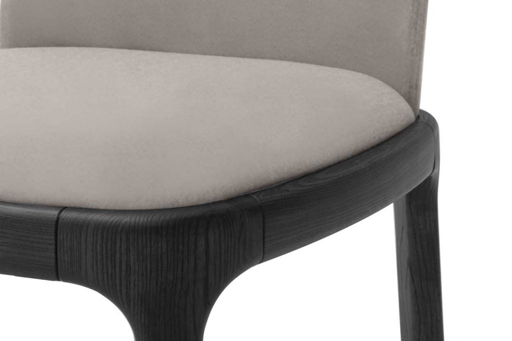 chair made of gray fabric and black wooden base on a white background