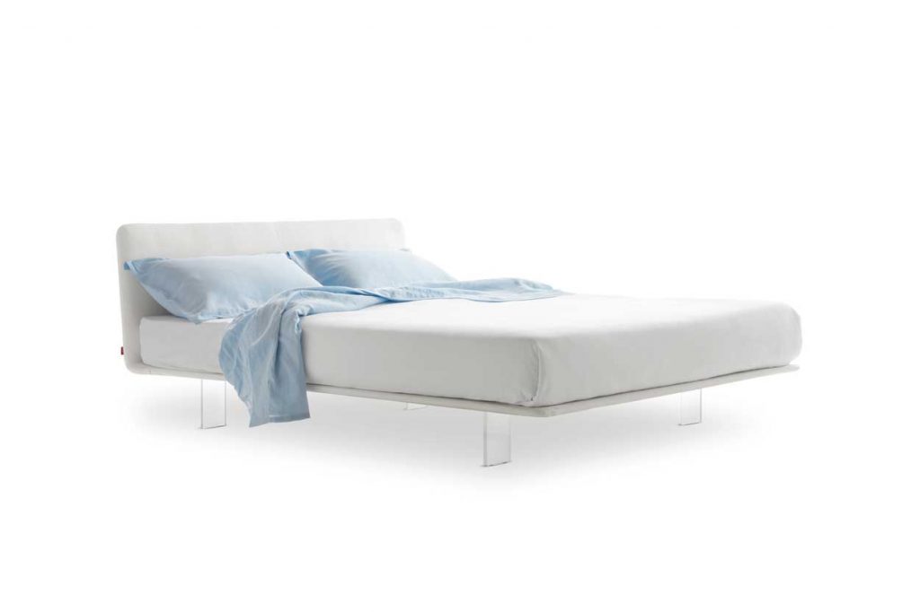 bed made with a cirstal base and upholstered in white leather on its back and white fabric