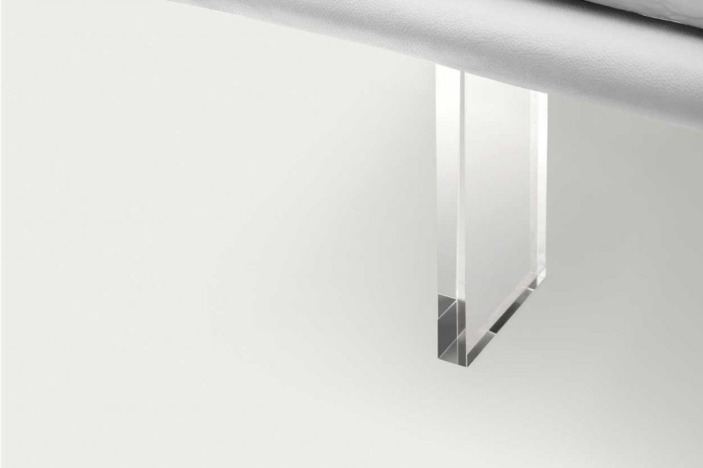 bed made of thick transparent glass legs on a white background