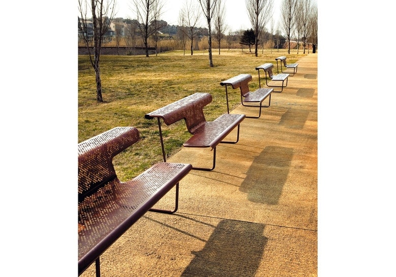 line of park benches made of steel in a bronze or brown tone