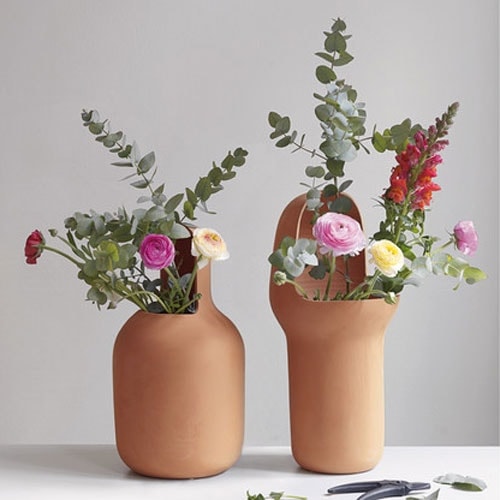 two vases made on a terracotta base with averutra on one side in an orange tone