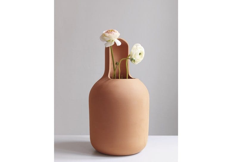 vase made of terracotta with a small opening in the middle with a flower inside