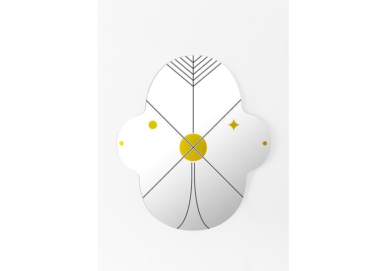 Two mirrors of different sizes with applied designs in gold and black on a white background
