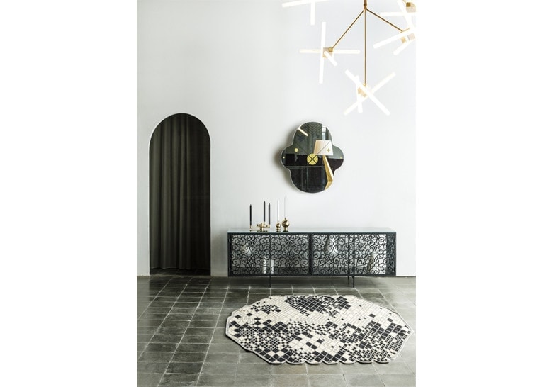 mirror made of two oval-shaped panels in a black and gold tone
