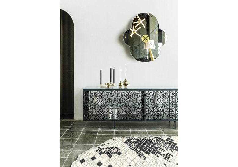 mirror made of two oval-shaped panels in a black and gold tone