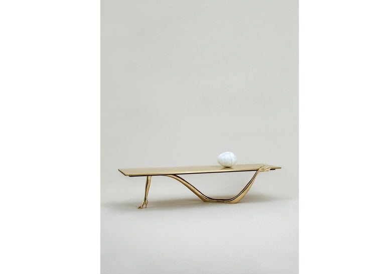 sculpture made of golden patina base and marble top in a golden tone