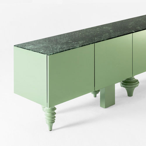 furniture made with legs designed in different styles made of flamed wood in a green tone