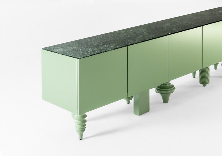 furniture made with legs designed in different styles made of flamed wood in a green tone