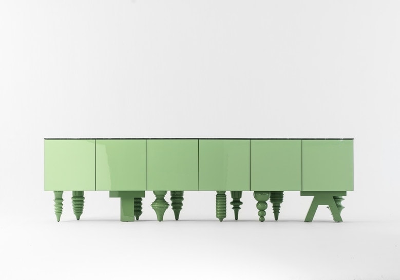 Furniture with front pressure drawers made of flamed wood base in a green tone on a white background