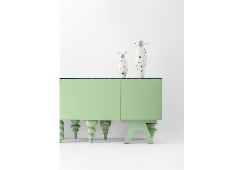 Furniture made of flamed wood in a green tone with front pressure drawers