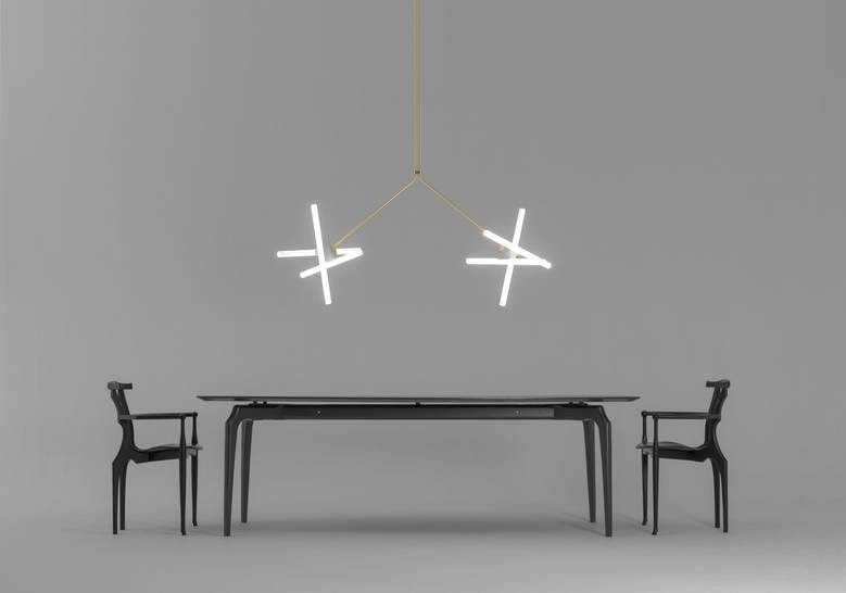 two hanging lamps made of steel in a golden tone with pine-shaped lights