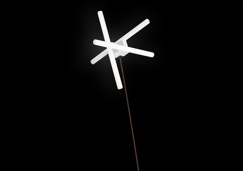 floor lamp made of steel base and 4-line star-shaped head on a black background