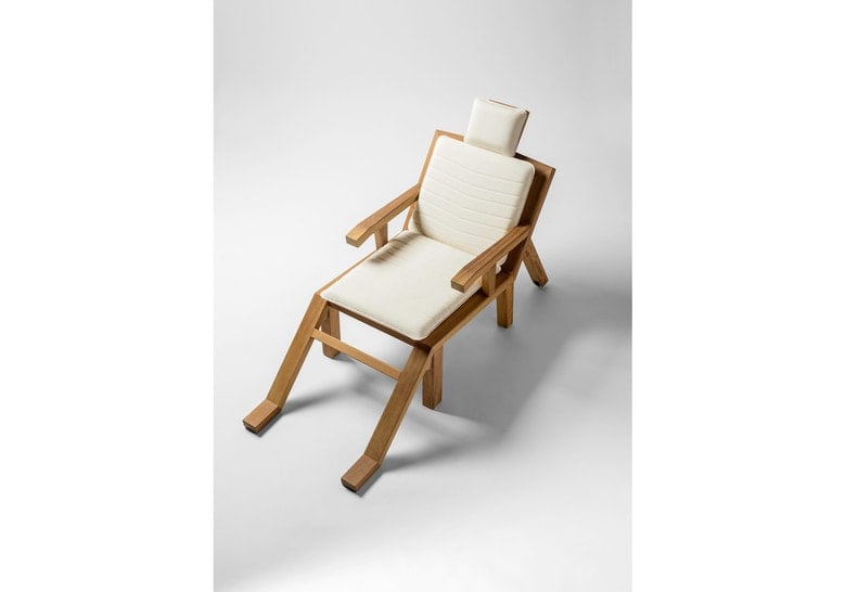 chair made of wood with white cushions, design in the shape of a human silhouette
