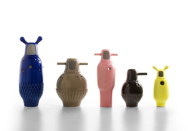 5 small sculptures made on a porcelain base in shades of blue, coffee, yellow, pink and black on a white background