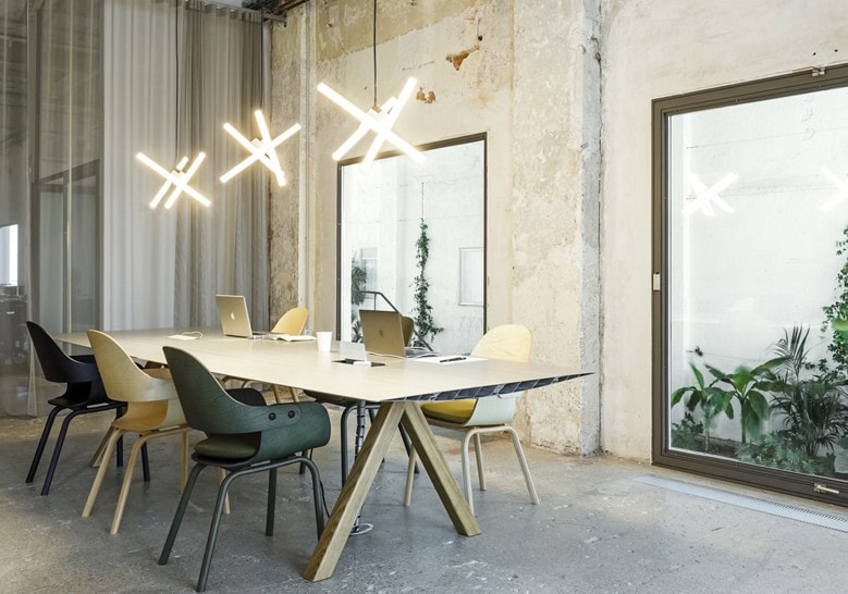 dining table made of steel base and aluminum top in a gold and beige tone