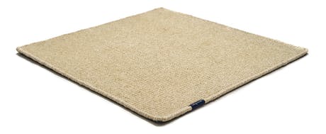 Handmade rug made of fine wool and fabrics in a cream tone on a white background