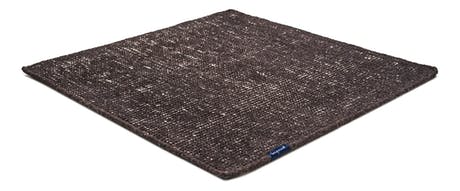 Handmade rug made of fine wool and fabrics in a stone tone on a white background